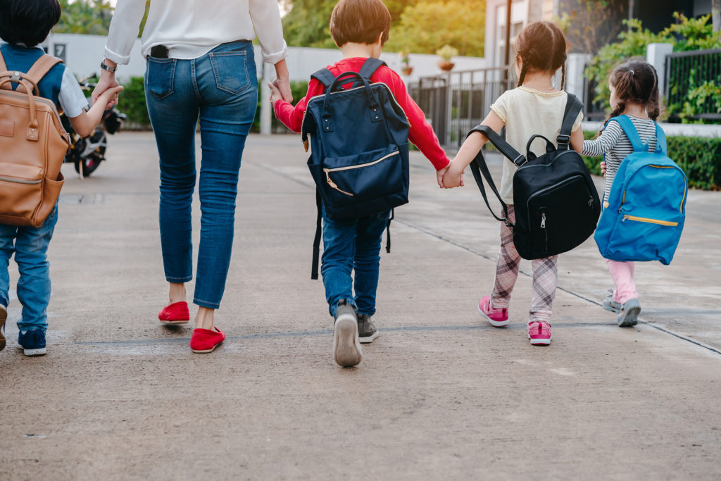 kid holding backpack